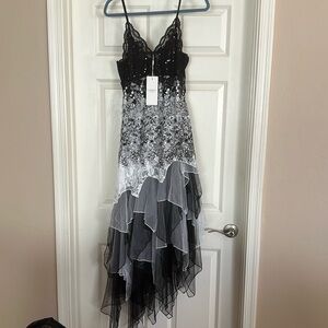 Brand new, never worn black and white dress. Very pretty!!! Lace and sequins.